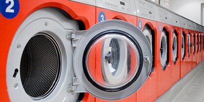 Washing machines with glass doors inside of laundromat
