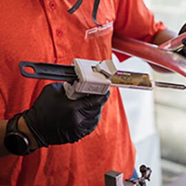 Technician uses applicator to bond metal with 3M metal glue