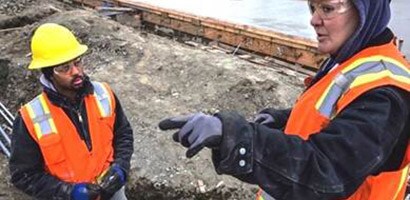 A 3M representative provides technical field support as she points to an area of concern on a construction site.
