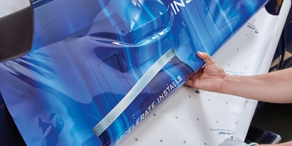 An arm reaches out to release a film liner.
