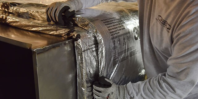 Worker installing a protective wrap
