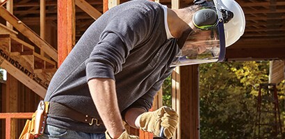 Worker wearing 3M™ Hearing Protection at a construction site.
