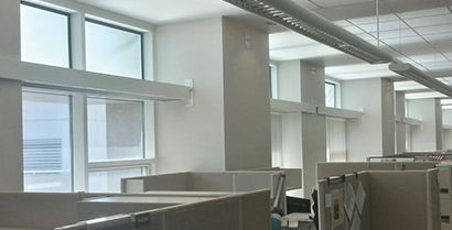 room with cubicles and windows
