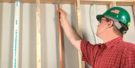 Inspector reviewing the firestop around a copper pipe as it goes up through a floor penetration
