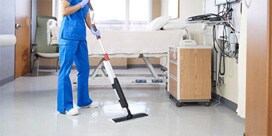 woman cleaning a patient room floor with the Scotch-Brite Professional Mopping and Floor Finish Applicator System
