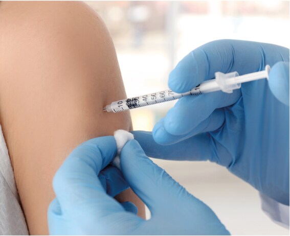 Healthcare worker administers vaccine into arm