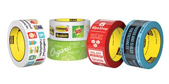 Image of several rolls of custom-printed tapes including both colored tapes and 4-color image printing
