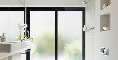 glass door with a white wall