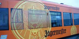 กราฟิกที่มีตราสินค้า Jagermeister สีส้มสดใสติดอยู่ที่ด้านข้างของรถราง