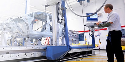 man working in an automotive manufacturing facility

