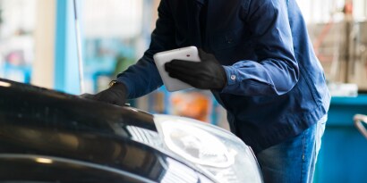 image of technician inspecting vehicle
