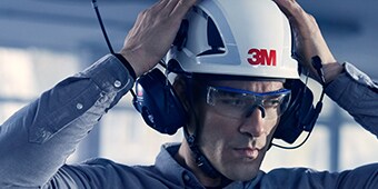 Man speaking into 3M Protective Communications headset
