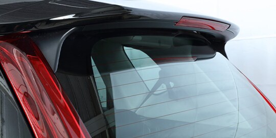 up close shot of red vehicle with 3M bonding attachment solutions on the rear window
