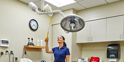 female worker cleaning a surgical suite
