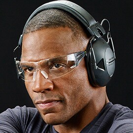 close up of a man wearing 3M Peltor passive hearing protection and sport safety eyewear