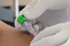 Disinfecting Port Protector (green cap) on a needleless connector

