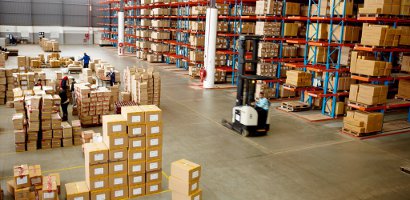 Warehouse with piles of boxes on floors and shelves
