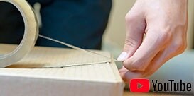 Image of a person starting a tape seal on a corrugated carton
