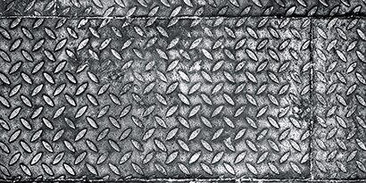 Plates of corrugated steel (diamond pattern) in industrial manufacturing
