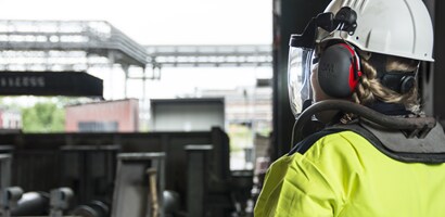 Worker wearing 3M Peltor protective communications on worksite
