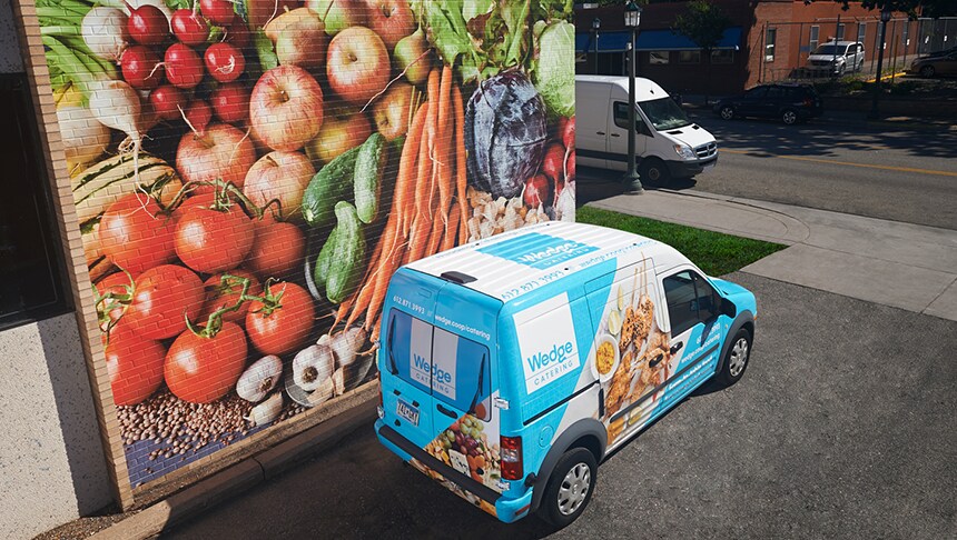 blue van on the side of a road

