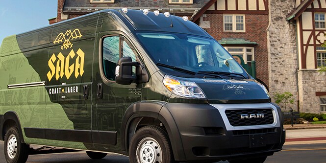 Delivery van wrapped with a graphic film displaying branded colors and logo.
