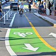 Clearly marked bike lanes with pavement markings in green, white and yellow.