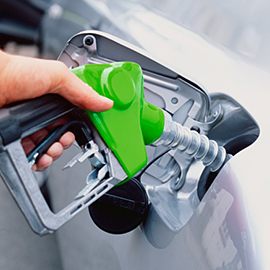 close up of person refueling a car