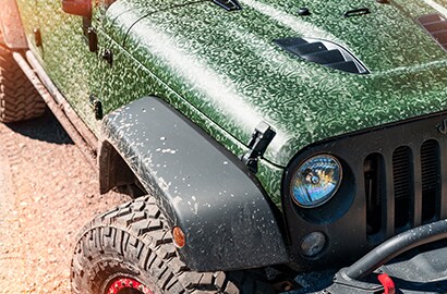 jeep driving through a field
