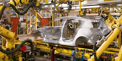 pre-assembly work being done at an OEM on a body-in-white vehicle
