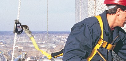 Worker at height with lanyard connected to cable rope grab
