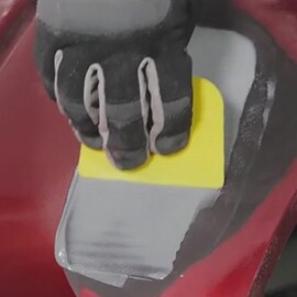 applying plastic material to bumper repair area