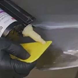 worker doing small damage metal dent repair