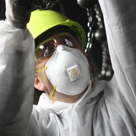 Worker wearing 3M disposible respirator
