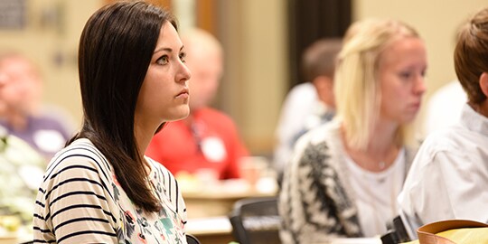 Attendees of HearForce Hearing Conservation Training at tables reviewing materials
